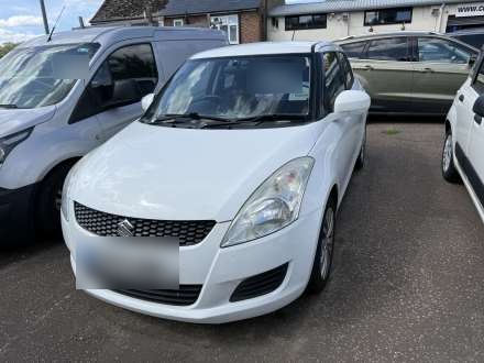 A white hatchback on the forecourt