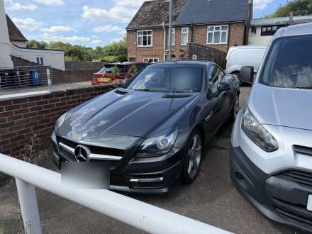 A black convertible on the forecourt